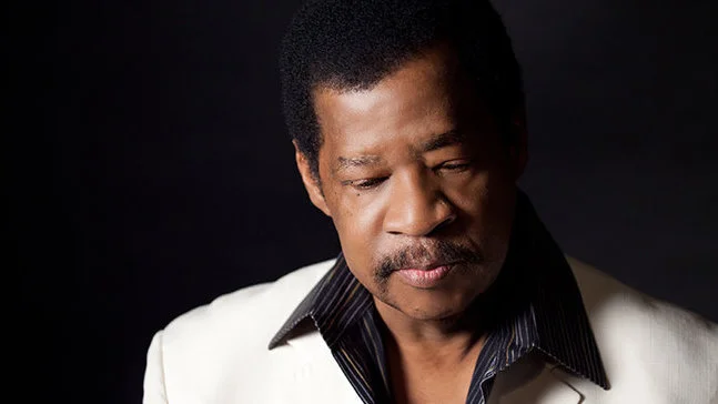 Jerry Lawson headshot photo wearing white suit